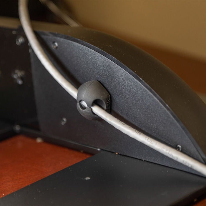 Using self-adhesive clip on computer desk for wire organization