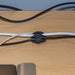 Organizing computer cables with 3-slot self adhesive cable mounting clip, side view