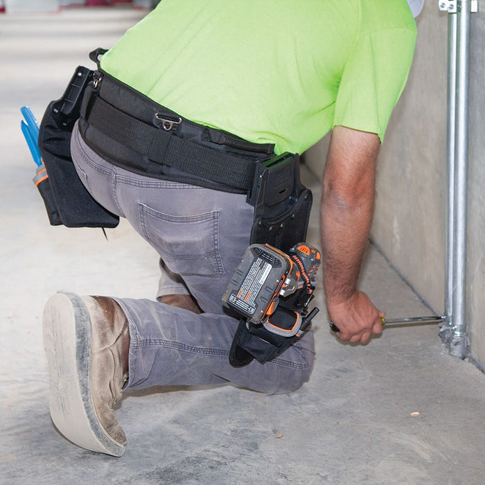 Fixing a metal conduit wearing Tradesman Pro™ Modular Drill Pouch
