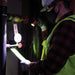 Professional electrician working in the dark with Klein Tools Rechargeable LED Flashlight
