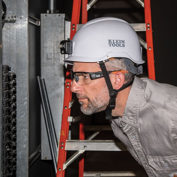 Man with Class-E hard hat checking a circuit breaker