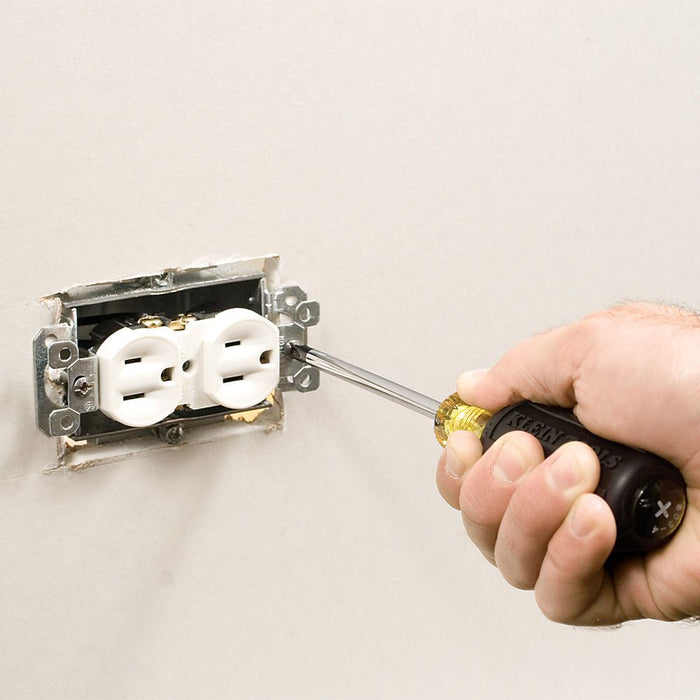 Tightening the screws on a outlet box with Klein tools screw driver