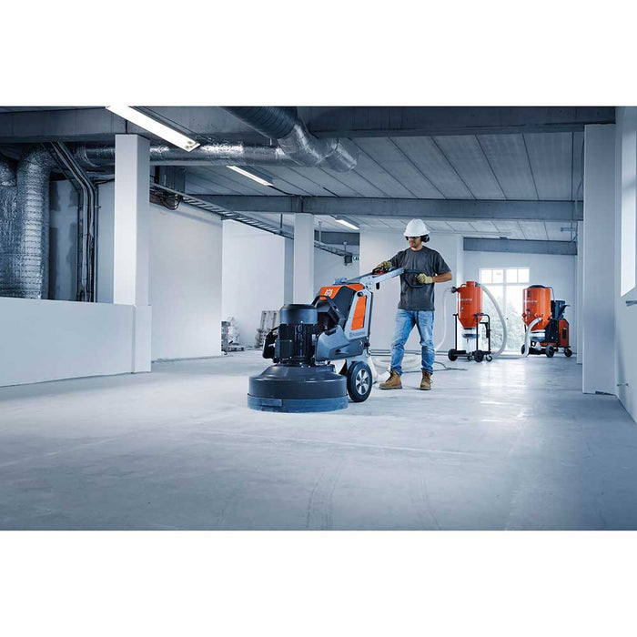 Grinding concrete floors with Husqvarna PG 830 S attached to pre separator and dust extractor