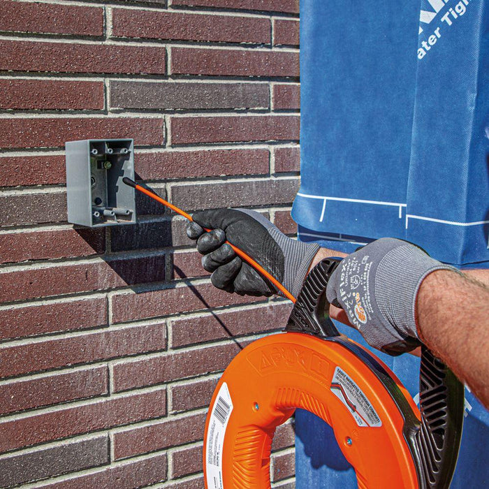  Inserting Klein Tools nylon tip of fish hook through outdoor brick wall