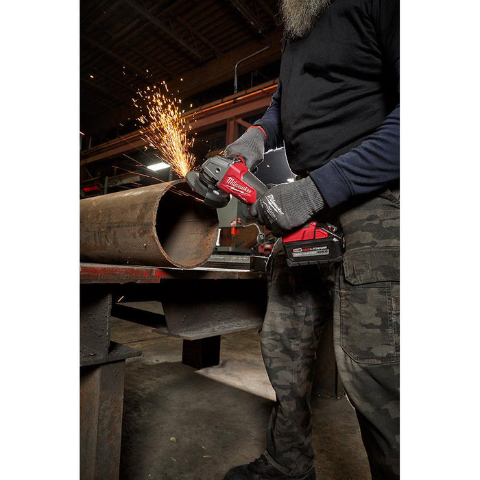 Cleaning up the edge of a cart iron pipe with Milwaukee angle grinder