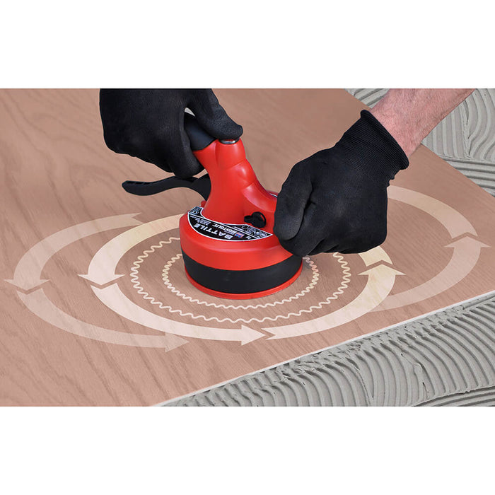 Vibrating porcelain tile to remove any voids in adhesion